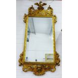 An ornate giltwood rectangular wall mirror, 125 x 60cm