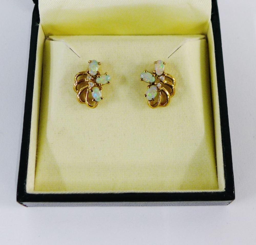 A pair of yellow metal opal and diamond set earrings, boxed