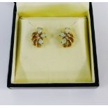 A pair of yellow metal opal and diamond set earrings, boxed