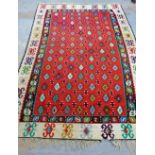 Large Kelim rug, the red field with multiple geometric motifs, 300 x 160cm
