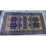 Eastern rug, blue field with geometric motifs and multiple flowerhead borders, 110 x 210cm