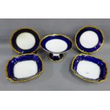 French porcelain dessert service with blue border and gilt edged rims, comprising a tazza, two