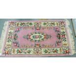 Chinese wool rug, pink field with floral border, 90 x 160cm