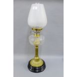 Brass oil lamp with glass well, ebonised base and opaque shade, 68cm high overall