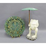 Modern circular Aztec style panel, together with a painted wooden frog figure, tallest 43cm high, (
