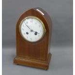 Mahogany and inlaid arched top mantle clock, the enamel dial with Arabic numerals on a rectangular