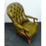 Green leather / vinyl upholstered button back open armchair, with carved arm rests and turned