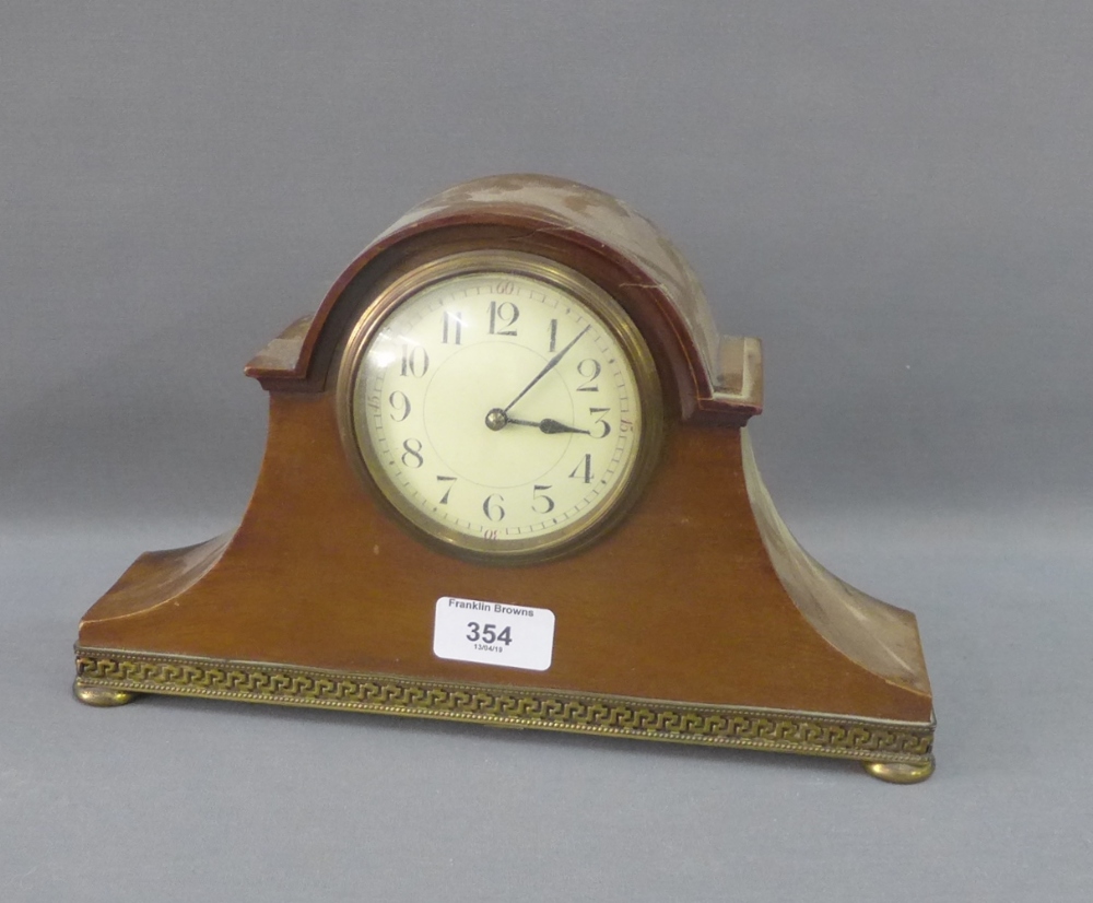 Mahogany and brass mounted mantle clock with enamel dial and Arabic numerals on four brass bun feet