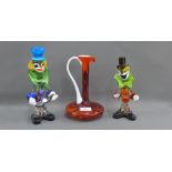 Two Murano coloured glass clowns together with an art glass carafe jug, tallest 25cm, (3)