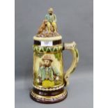 Continental pottery stein, the cover with a man and his dog, 33cm high