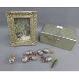 Silver coloured wooden box containing a collection of white metal bells, together with a faux silver