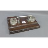 Art Deco mahogany ink stand with two glass wells and a chrome handle