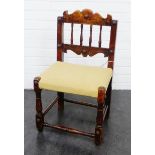 Stained oak child's chair, with a shaped top rail and spindle back, upholstered seat and turned