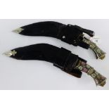 Two Eastern style Kukri daggers with leather sheaf's and enamel work to the handles (2)