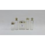 Edwardian set of five silver topped glass bottles, London 1906, tallest 14cm