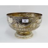 Victorian silver punch bowl with half fluted decoration and garland swags, on circular footrim,