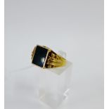 Gents 9 carat gold ring with green rectangular hardstone plaque and scrolling shoulders, UK ring