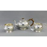 George V silver teaset comprising teapot, sugar bowl and cream jug, by James Ramsay, London 1935 (3)