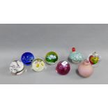 Collection of eight coloured glass paperweights to include Caithness glass etc., (8)