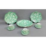 Chinese green and white glazed porcelain tea wares with blossom pattern, comprising three cups,