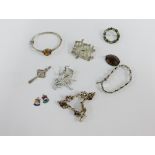 A collection of silver and white metal jewellery to include brooches, bangle, bracelets and Iona