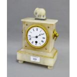 White hardstone mantle clock with lion mask head handles to side, surmounted by an elephant,