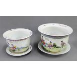 Two Chinese Famille Rose jardiniere and stands painted with figures, in a garden setting, with