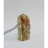 Chinese green and red hardstone pendant plaque of Shoulao modelled standing holding three peaches,