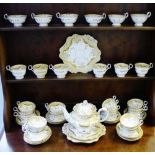 Quantity of Rockingham style porcelains comprising thirty cups, a teapot, three cake plates and