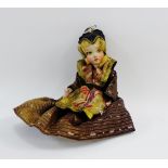 Early 20th century costume doll with painted face and cloth limbs, 22cm long