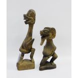 Tribal Art carved wooden male fertility figures, with grotesque faces and triangular plinth bases,