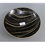 Arabia Finland black glazed pottery bowl on circular foot rim with printed backstamps, 25cm