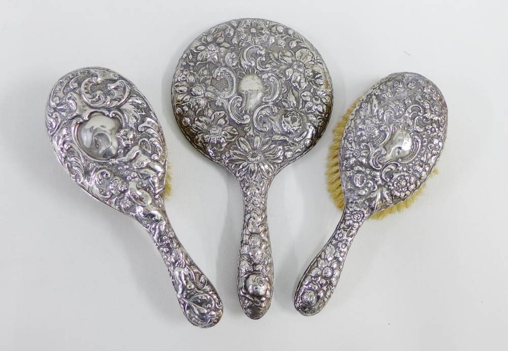 A collection of early 20th century silver backed brushes and mirrors (3)