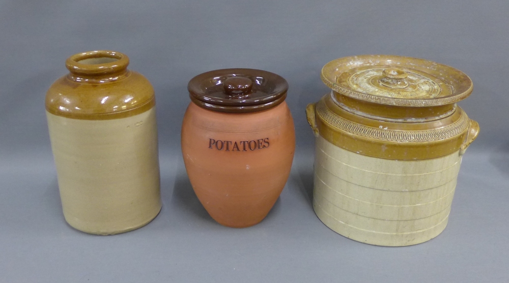 Two stoneware crocks and a terracotta potato jar and cover, (3)