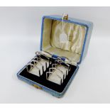 George V pair of silver toastracks, in a fitted leather box, by Davidson, Henderson & Sorley,