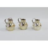 Three Edwardian silver miniature Guernsey milk pots, one as a pepper pot with detachable lid,