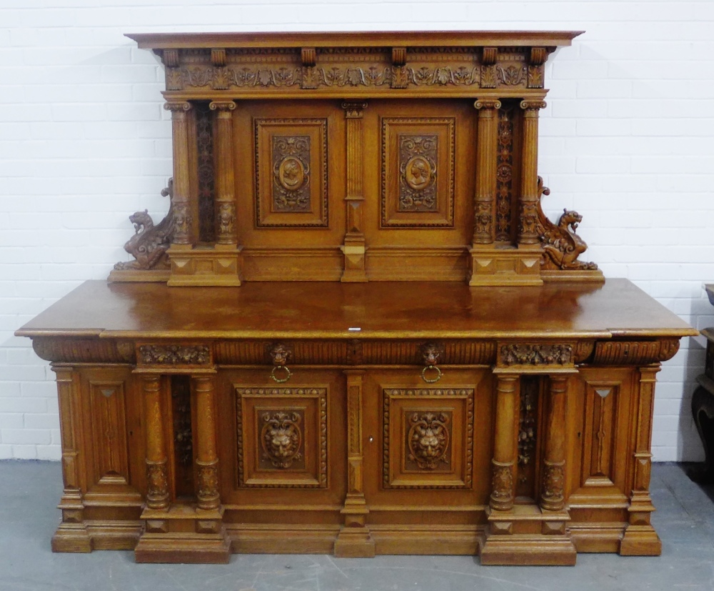 Large carved oak and walnut sideboard, the galleried back surmounted by a pediment top over dentil