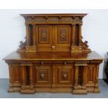Large carved oak and walnut sideboard, the galleried back surmounted by a pediment top over dentil