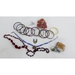 A mixed lot to include amber beads, gold plated bangle, various pendants, brooches, earrings and