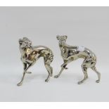 Two white metal greyhound figures, 14cm high (2)