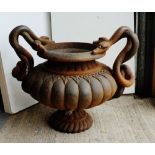 Cast iron planter of circular form with serpent handles, 56cm x 70cm