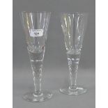 Pair of large glasses with facet cut stem and circular foot rim and flared bowl, 28cm high, (2)