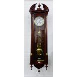 Modern wall clock with a broken pediment, urn finial and brass capped pilasters, an enamel dial with