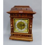 Oak cased mantle clock, the brass dial with a silver chapter ring with Roman numerals and Cherub