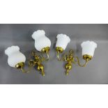 Five various twin branch brass and opaque glass wall lights, (5)