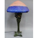 After Moreau, faux bronze Art Nouveau style table lamp base with blue and red glass shade, 63cm high