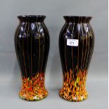 Pair of black art glass baluster vases with orange and yellow inclusions, 30cm high, (2)