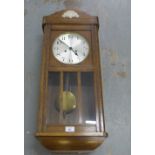 An oak cased wall clock