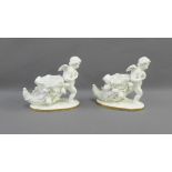 Two Moore white glazed porcelain Cherub and cornucopia posies on oval gilt edge bases with Greek Key