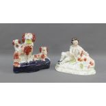 Staffordshire boy and hound figure group, together with a Staffordshire three dog pen holder,